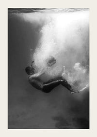 Black and white photograph of man sinking below water surface-3