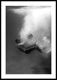 Black and white photograph of man sinking below water surface-0
