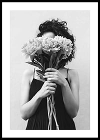 Schwarz-Weiß-Foto einer Frau mit lockigem Haar, die einen Blumenstrauß hält-0