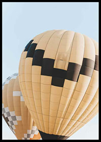 Photograph of yellow and black hot air balloons against blue sky-6