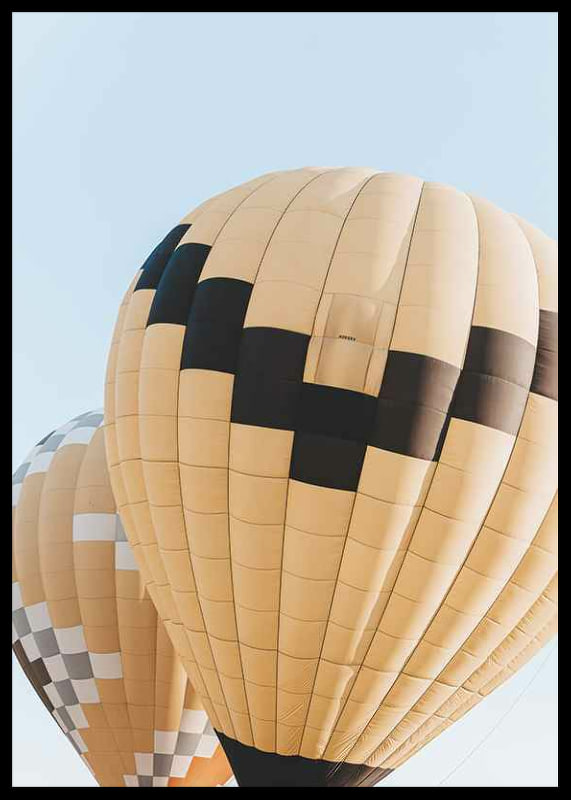 Photograph of yellow and black hot air balloons against blue sky-12