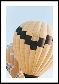 Photograph of yellow and black hot air balloons against blue sky-0