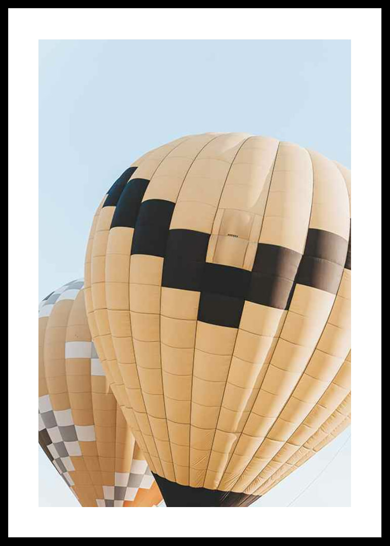 Photograph of yellow and black hot air balloons against blue sky-12