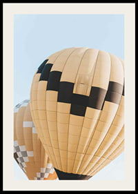 Photograph of yellow and black hot air balloons against blue sky-2