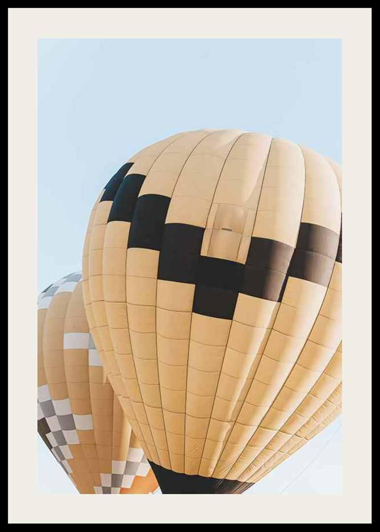 Photograph of yellow and black hot air balloons against blue sky-12