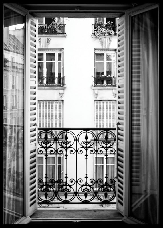 Black and white photo of open window with wrought iron balcony-12