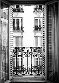 Black and white photo of open window with wrought iron balcony-7
