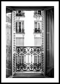 Black and white photo of open window with wrought iron balcony-0