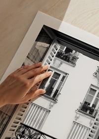 Black and white photo of open window with wrought iron balcony-9