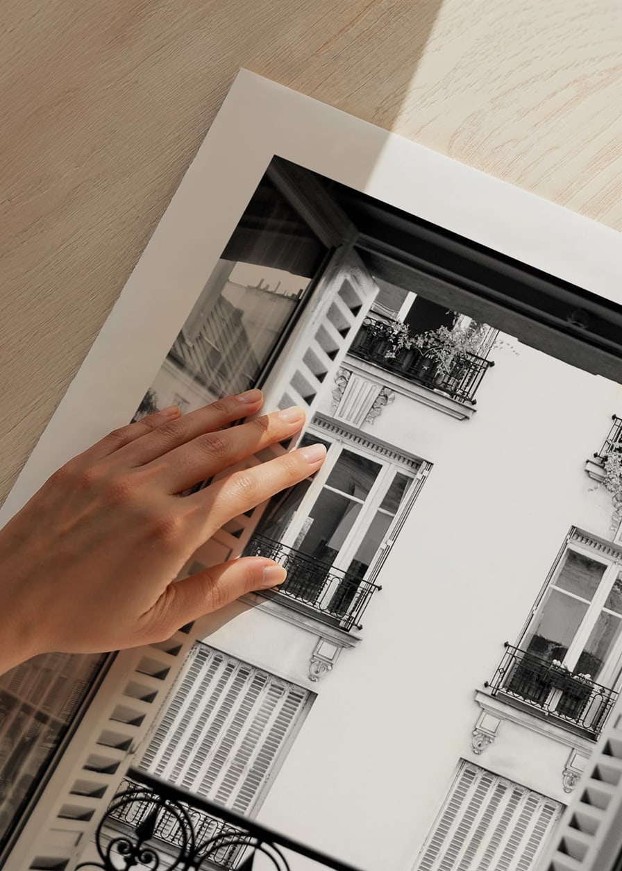 Black and white photo of open window with wrought iron balcony-12