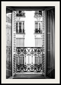 Black and white photo of open window with wrought iron balcony-2