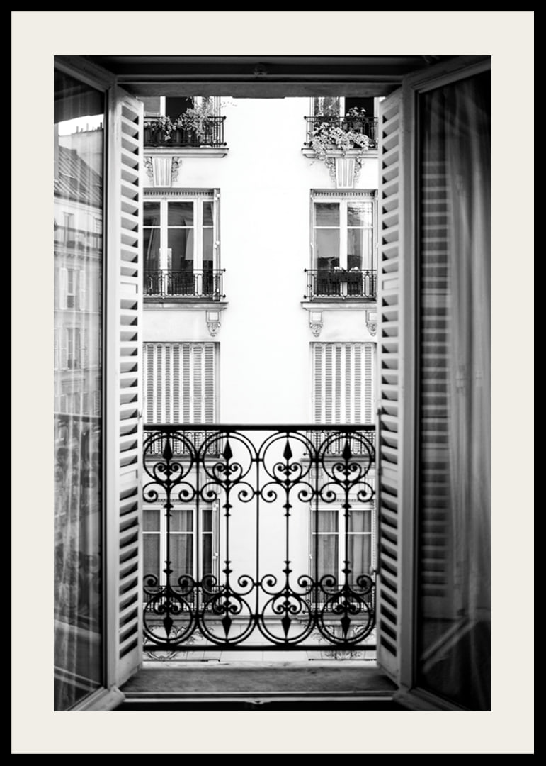 Black and white photo of open window with wrought iron balcony-12