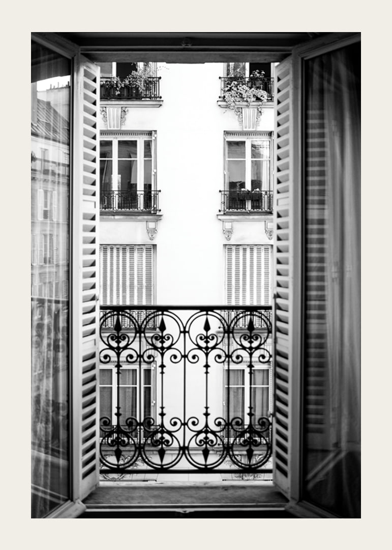 Black and white photo of open window with wrought iron balcony-12