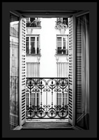 Black and white photo of open window with wrought iron balcony-4