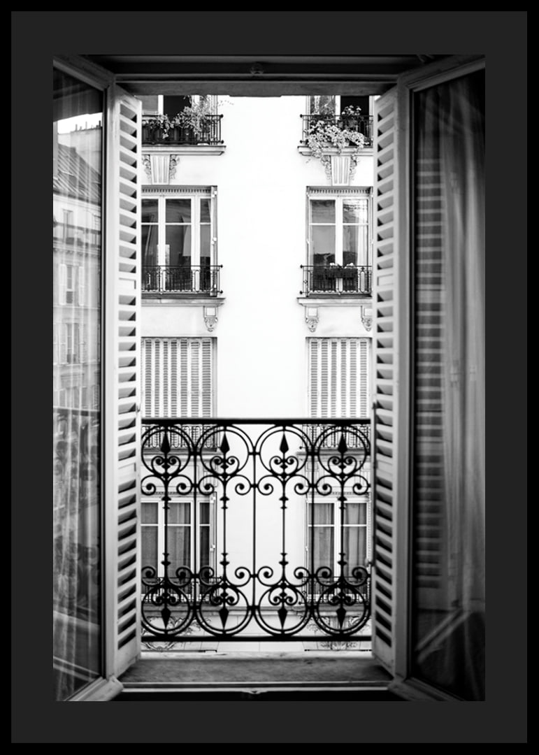 Black and white photo of open window with wrought iron balcony-12