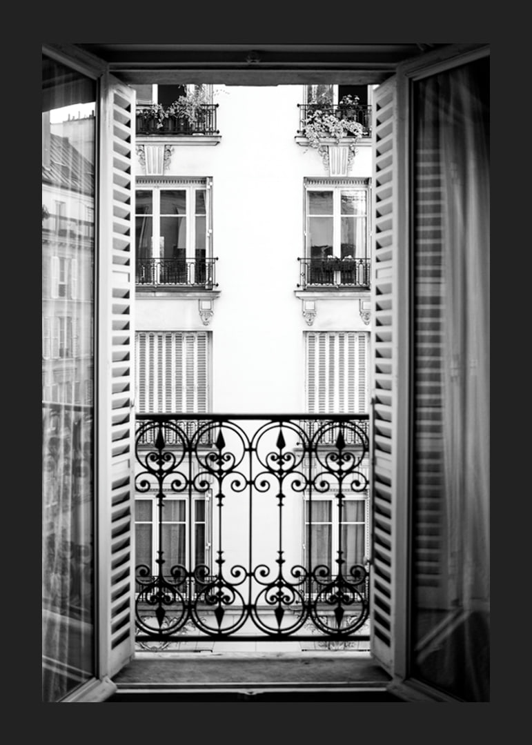 Black and white photo of open window with wrought iron balcony-12