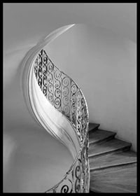 Black and white photograph of spiral staircase with wrought iron railing-6