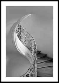 Black and white photograph of spiral staircase with wrought iron railing-0