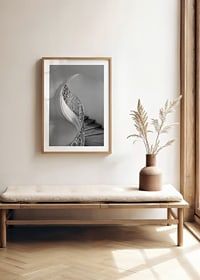 Black and white photograph of spiral staircase with wrought iron railing-8