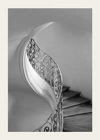 Black and white photograph of spiral staircase with wrought iron railing-3