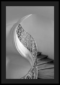 Black and white photograph of spiral staircase with wrought iron railing-4