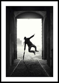 Black and white photograph of jumping man with umbrella in tunnel-0