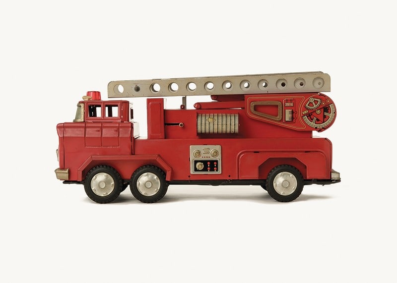 Retro toy fire truck in red against light background-12