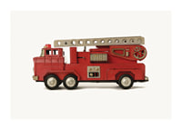 Retro toy fire truck in red against light background-1