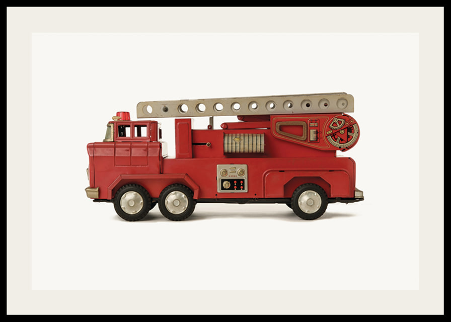 Retro toy fire truck in red against light background-12
