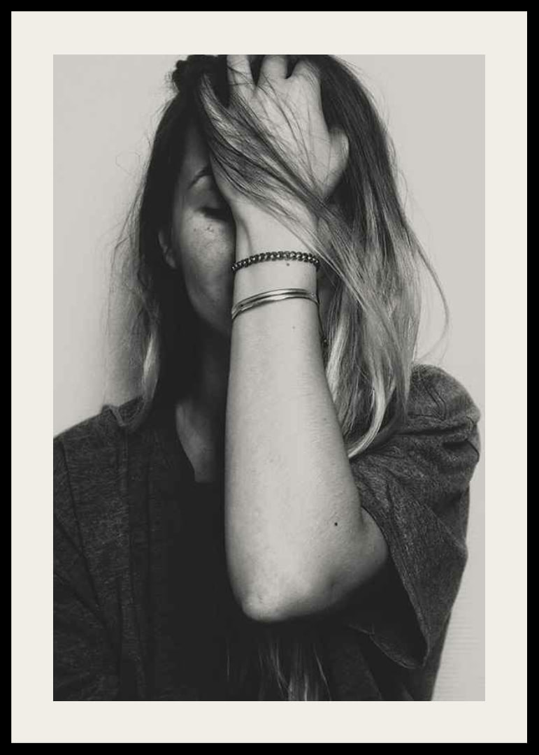 Black and white portrait of woman with hand over face-12