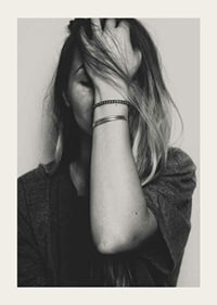 Black and white portrait of woman with hand over face-3