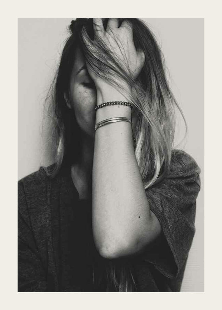 Black and white portrait of woman with hand over face-12