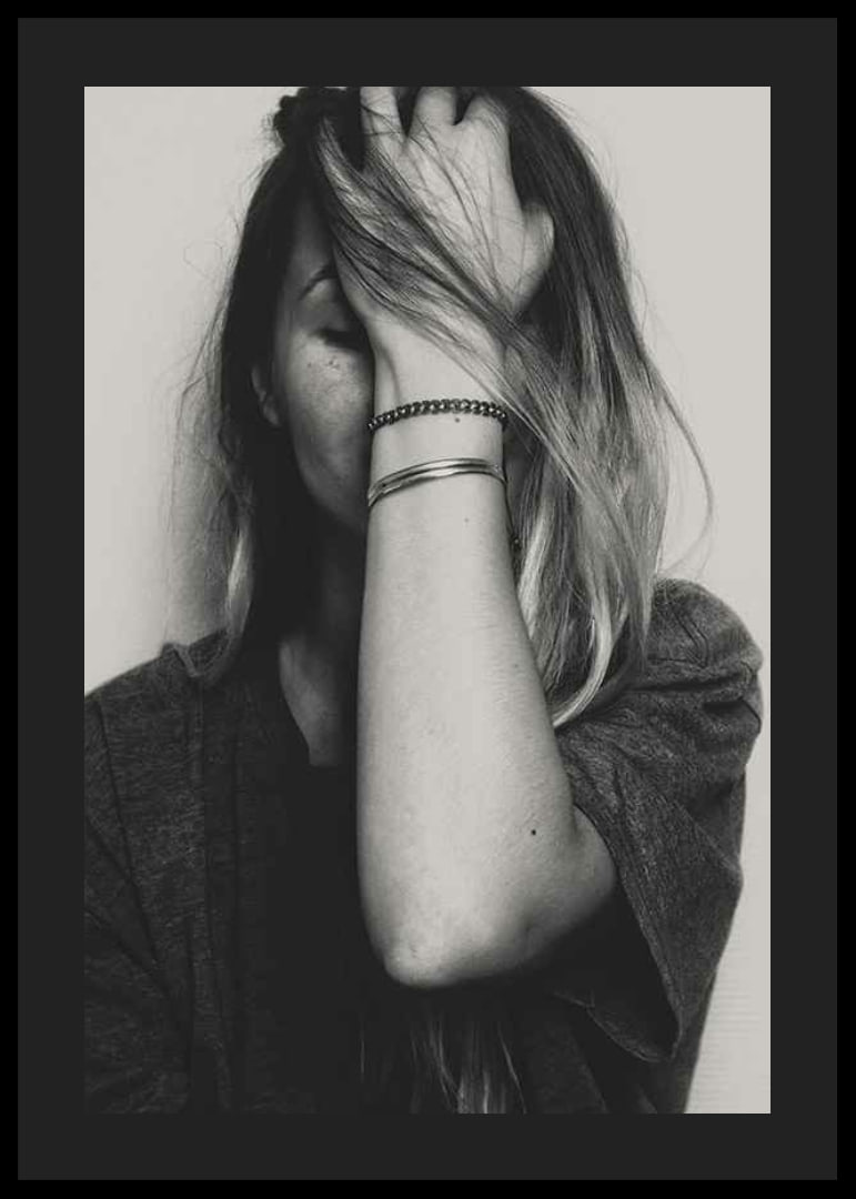 Black and white portrait of woman with hand over face-12
