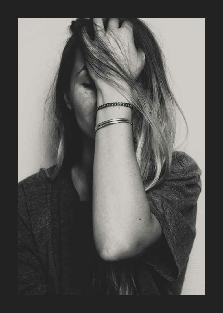 Black and white portrait of woman with hand over face-12