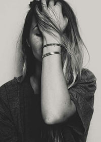 Black and white portrait of woman with hand over face-7