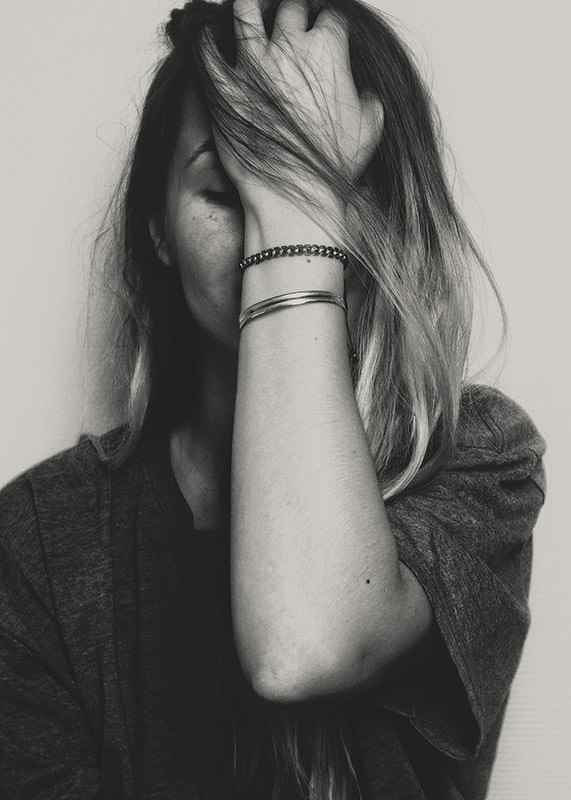 Black and white portrait of woman with hand over face-12
