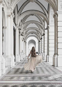 Photograph of woman in beige dress under arches-7