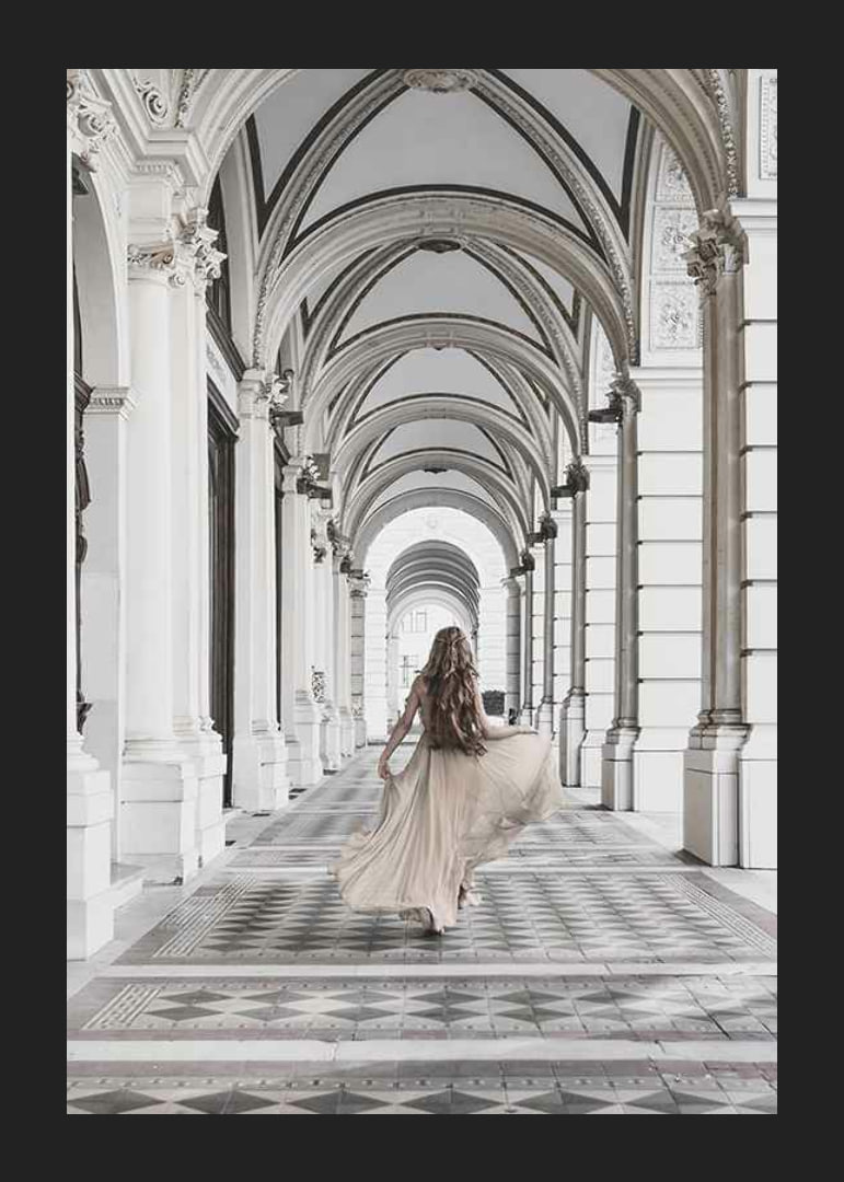 Photograph of woman in beige dress under arches-12