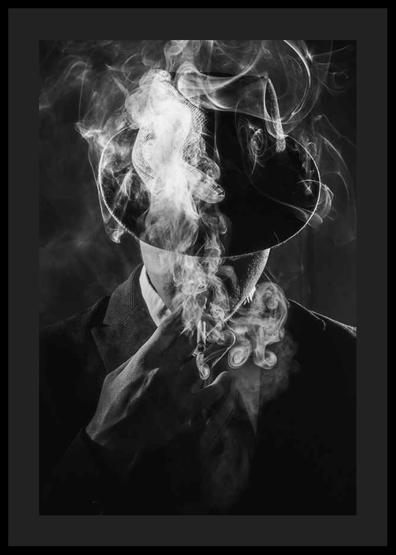 Black and white portrait of man in hat surrounded by cigarette smoke-12