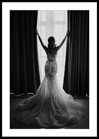 Black and white photo of woman in lace dress by open window-0