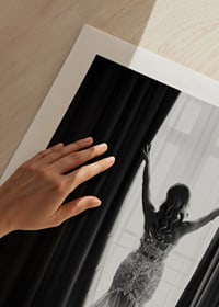 Black and white photo of woman in lace dress by open window-9