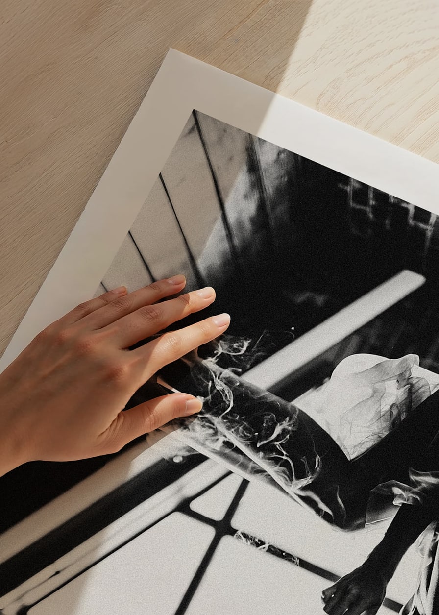 Black and white photograph of woman smoking in bed by window-12