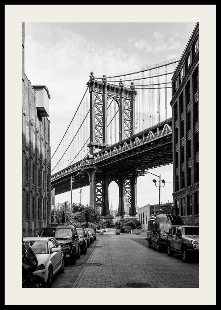 Black and white photograph of Manhattan Bridge between buildings-12