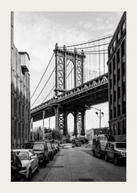 Black and white photograph of Manhattan Bridge between buildings-3
