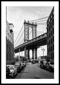 Black and white photograph of Manhattan Bridge between buildings-0