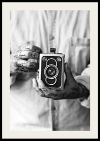 Black and white photo of tattooed hands holding a retro camera-2