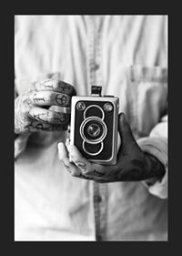 Black and white photo of tattooed hands holding a retro camera-5