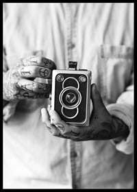 Black and white photo of tattooed hands holding a retro camera-6