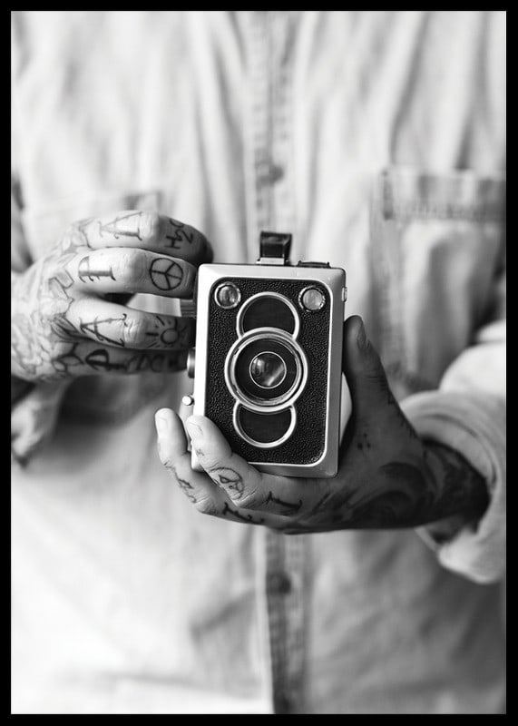 Black and white photo of tattooed hands holding a retro camera-12