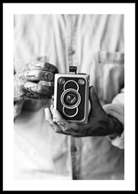 Black and white photo of tattooed hands holding a retro camera-0